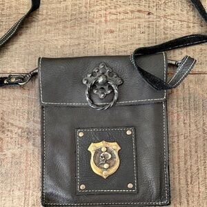Black Leather Crossbody with Decorative Metal Badge
